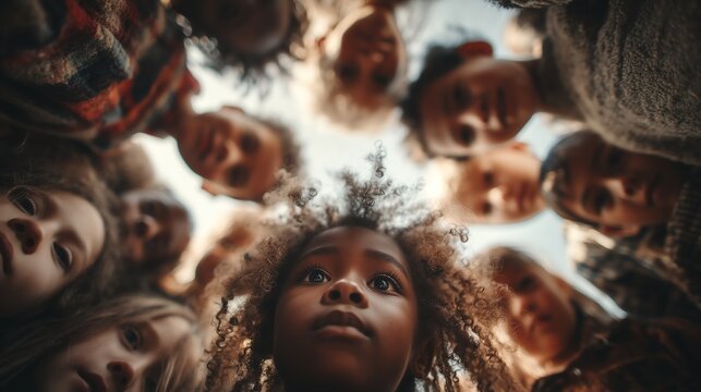 Diverse global community of adults and children gazing upwards under soft, warm lighting, a simple yet powerful composition with ample copy space for messaging