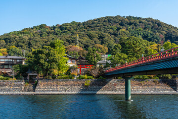 Scenic sight on a sunny autumn morning along the Uji river in Kyoto, Japan.