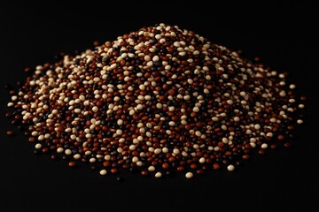 Red, black, and white tricolor quinoa against a dark backdrop