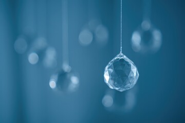 Out-of-focus hanging glass orbs against a dark blue backdrop with subtle lighting