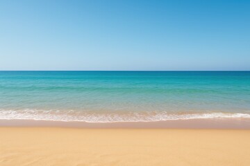 Fototapeta premium A sandy shoreline meeting the ocean with ample space for text