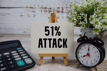 51% Attack text with alarm clock and calculator on wooden background