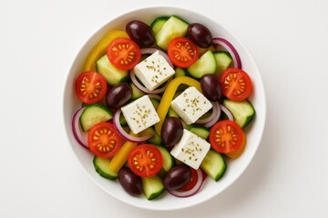 Refreshing Mediterranean dish with feta, olives, cherry tomatoes, yellow peppers, cucumber, and onions on a white surface