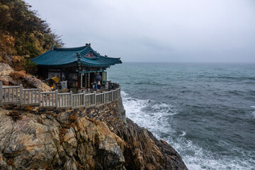 temple building on the seaside cliff in the rain