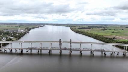 A stunning Aerial View of Pacific Highway Harwood Bridge crosses the Clarence River under a cloudy...