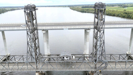 A stunning Aerial View of Pacific Highway Harwood Bridge crosses the Clarence River under a cloudy...