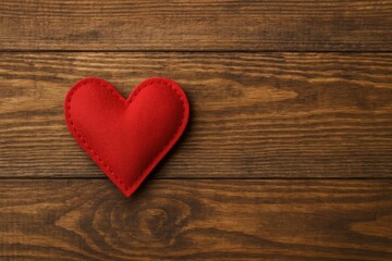 Fabric heart placed on wooden surface for Valentine's celebration
