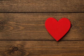 Fototapeta premium Love symbol on rustic wooden surface with romantic setting and Valentine's Day message space