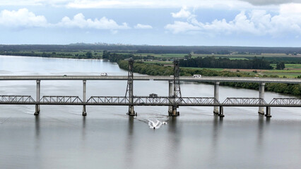 A stunning Aerial View of Pacific Highway Harwood Bridge crosses the Clarence River under a cloudy sky in the Northern Rivers region of New South Wales, Australia 
