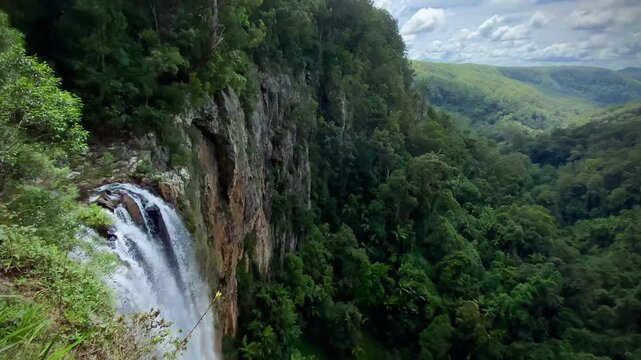 Waterfall Cascading Through Rocky Terrain in Natural Landscape at Springbrook National Park, Australia 