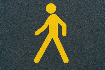 Vivid yellow walking figure icon for pedestrians