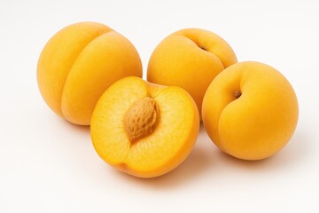 Golden peach fruits on a plain white backdrop