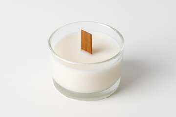 Wooden wick paired with a candle holder on a plain white surface
