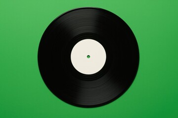 Obraz premium Retro-inspired vinyl record for a dance party on a green background