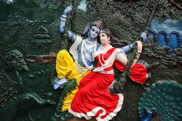 A Mural art of Hindu mythological Gods 'Radha Krishna' on a swing, colorful, intricate, carving, 3D...
