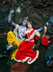 A Mural art of Hindu mythological Gods 'Radha Krishna' on a swing, colorful, intricate, carving, 3D design, fine art, home decor, wall hanging, home decoration in India. © priya