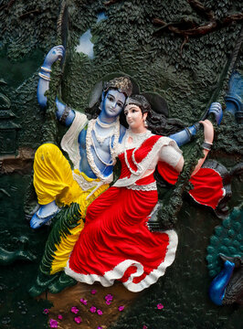 A Mural art of Hindu mythological Gods 'Radha Krishna' on a swing, colorful, intricate, carving, 3D design, fine art, home decor, wall hanging, home decoration in India.