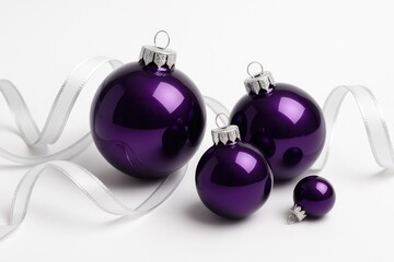 Elegant shiny purple holiday ornaments adorned with white and silver ribbons on a plain white backdrop