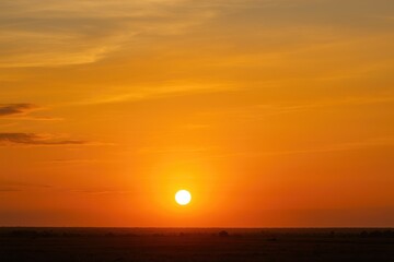 Fototapeta premium A sunset scene with a vibrant sky in the background