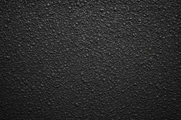 Fototapeta premium Dark asphalt surface with gravel texture
