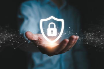 A hand presents a digital shield with a padlock for cybersecurity