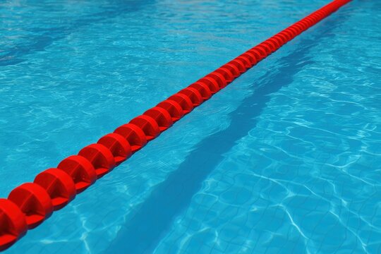 Splitting the red floating marker in the clear pool water