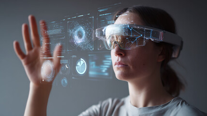 Woman using augmented reality smart glasses with holographic data interface and futuristic charts