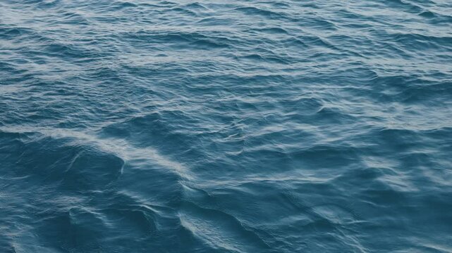 Slow motion closeup shot of ocean water surface
