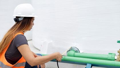 Worker Inspects Machinery in Industrial Facility