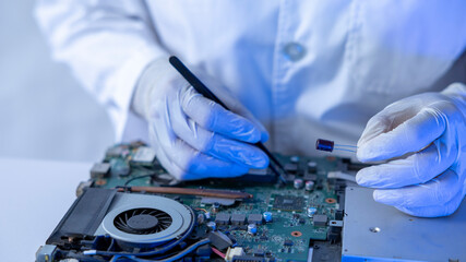 Tech Fixes Motherboard in Lab