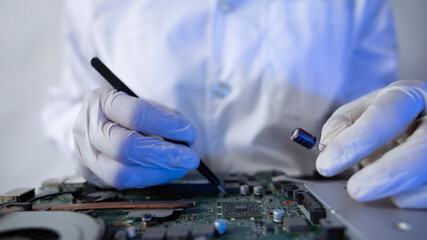 Tech Fixing Circuit Board in Lab