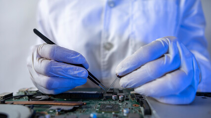 Technician Repairing Circuit Board in Clean Lab