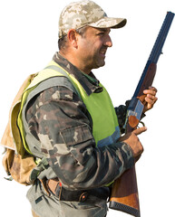 Silhouette of a hunter with a gun in the reeds against the sun, an ambush for ducks with dogs
