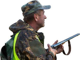 Silhouette of a hunter with a gun in the reeds against the sun, an ambush for ducks with dogs