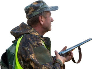 Silhouette of a hunter with a gun in the reeds against the sun, an ambush for ducks with dogs