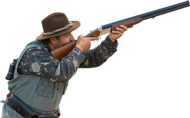 Silhouette of a hunter with a gun in the reeds against the sun, an ambush for ducks with dogs