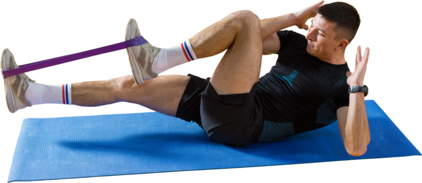 Athletic guy in sportswear and fitness tracker doing exercises in gym.