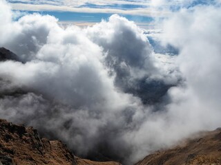 a sea of ​​clouds arriving over the mountain ridge