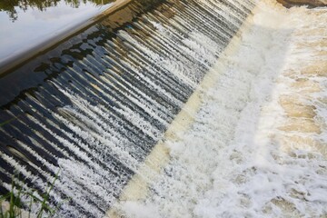 Hydroelectric plant on the river, water flows