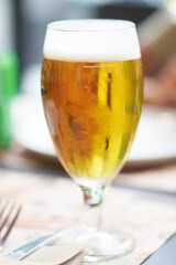 glass of very cold beer with foam