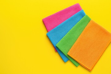 Vibrant microfiber cleaning cloths displayed against a cheerful yellow backdrop