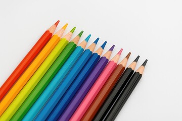 Fototapeta premium Vibrant colored pencil set on plain white backdrop
