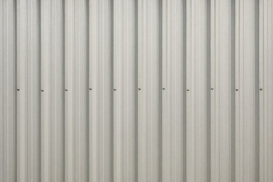 View of a corrugated gray metal wall from the side