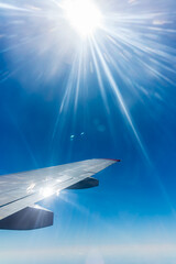 View on sunset and airplane wing from the inside