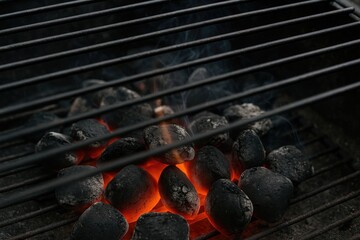 Cooking with glowing charcoal on a barbecue grill
