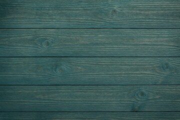 Naklejka premium Blue over green with a wooden backdrop