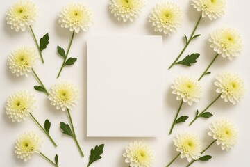 Elegant flower display featuring chrysanthemums on a white table with a card mockup from a top-down perspective