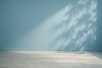 Interior of a blue wall kitchen studio with shadow effects and textured flooring, featuring an empty concrete wall with abstract nature shadows and smoky highlights for seasonal product design