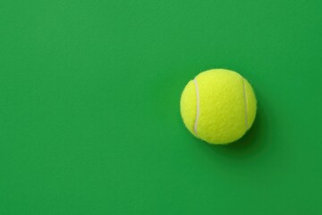 Top-down view of a tennis ball on a vibrant green surface mockup