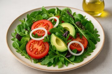 Fresh and nutritious vegetable salad featuring sliced tomatoes, creamy avocado, onion, and leafy greens drizzled with olive oil